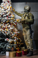 a soldier decorates a Christmas tree. a man in a military uniform decorates a Christmas tree