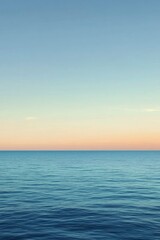 Fototapeta premium Calm Ocean Surface with Soft Pink Sunset Sky