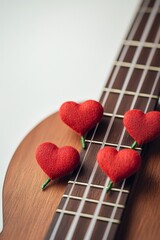 Romantic Serenade Close-Up of Wooden Acoustic Guitar with Heart Decorations on Strings, Love Music Concept for Valentine's Day