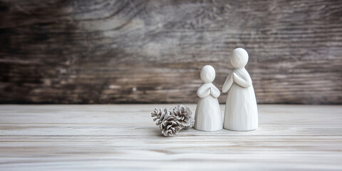 Minimalistic Christmas wooden background with praying figures and space for text