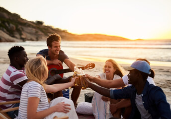 Group, friends and alcohol for picnic or social by beach on holiday, vacation or break. People, toast and fun with bonding together for summer season, wellness or outdoor adventure by ocean in Greece