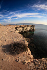 Visitors enjoy the stunning coastal views of Cyprus during a clear afternoon, highlighting natural rock formations and serene waters