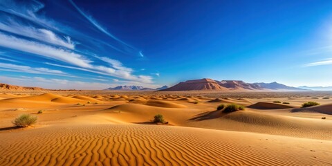 Naklejka premium Desert landscape with clear blue sky in the background, Desert, Landscape, Blue Sky, Background, Nature, Arid, Dry, Sand