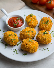 Homemade chicken nuggets with tomato sauce.