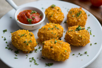 Homemade chicken nuggets with tomato sauce.