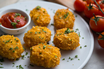Homemade chicken nuggets with tomato sauce.