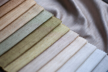 Samples of fabrics for curtains in pastel colors close-up. The color palette of the fabric