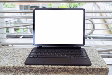 Digital tablet screen is blank on the marble table, mockup for presentation template.