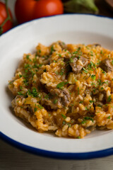 Rice paella with Iberian pork cheek. Traditional spanish tapa with iberic pork.