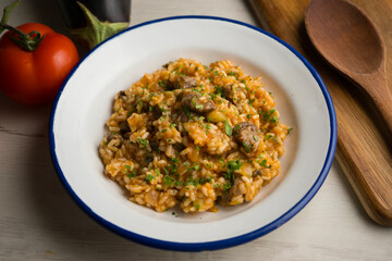 Rice paella with Iberian pork cheek. Traditional spanish tapa with iberic pork.