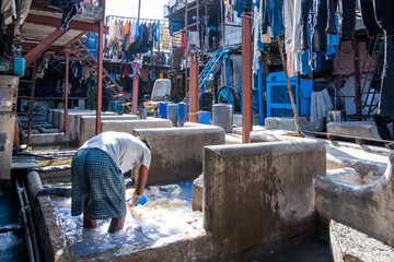 A man washing clothes in Dhobi Ghat, the open air laundry in Mumbai, India