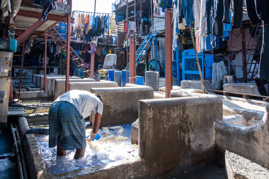A man washing clothes in Dhobi Ghat, the open air laundry in Mumbai, India