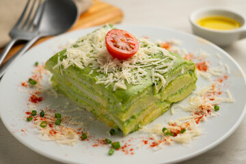 Baked potatoes with spinach bechamel and cheese.