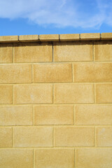 Muro amarillo de bloques de hormigón en exterior soleado