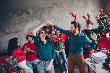 Portrait of group friends colleagues enjoy dancing chilling christmas party loft office indoors