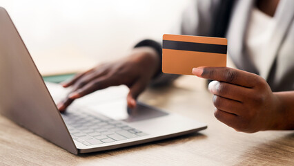 Easy Payments. Unrecognizable Black Businesswoman Using Credit Card And Laptop At Workplace In Office.