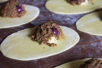 Photograph of meat empanadas preparation.