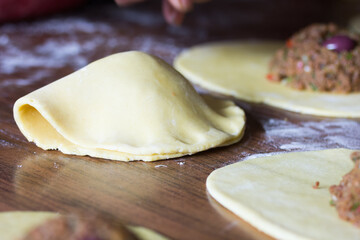 Photograph of meat empanadas preparation.
