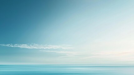 Obraz premium Serene meeting of blue ocean and sky with light clouds, exuding calmness and tranquility, perfect for relaxation and contemplation, offering a sense of freedom and vastness in nature