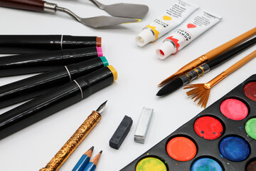 art supplies brushes, paint and pens
