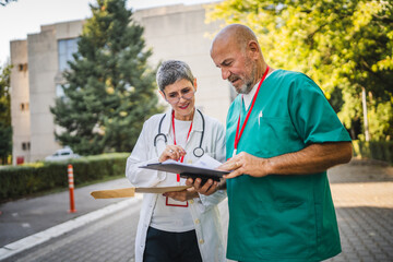 doctors analysis and review patient files from clipboard and envelope