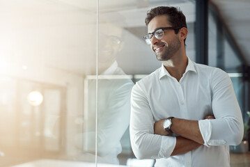 Thinking, happy and business man with arms crossed in office on glass wall for insight, mindset or inspiration. Confident worker, idea and planning future, vision or reflection for view or job growth © BestCam/peopleimages.com
