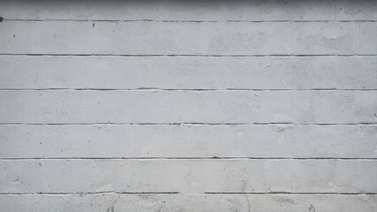 The walls are painted white and gray. Texture of concrete wall or brick wall. The old wall has some rough patches.