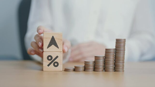 wood block of percentage change to UP and Down arrow with money coins stack. Interest rate, GDP, stocks market, financial, deflation and Inflation, ranking, mortgage, debt, Loan and Economic Recession