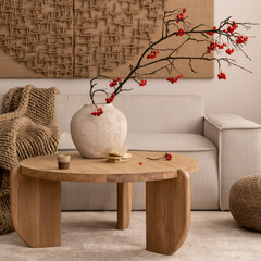 Warm composition of living room interior with mock up postrer frame, vase with rowan, wooden coffee...