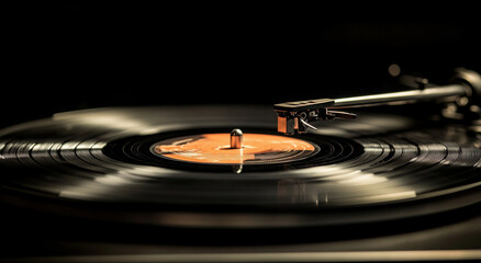Close-up of a needle on an old record player spinning a classic vinyl record