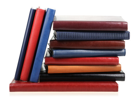 Stack of diaries or books with colorful covers on white background