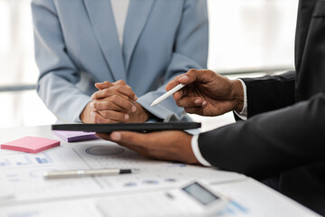 Business colleagues working and analyzing financial figures on a digital tablet. Analysis business financial report on digital tablet discussion meeting corporate showing results of their successful.