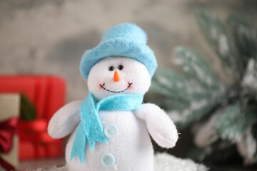 Funny snowman figure in hat on table, closeup