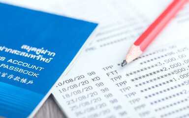 Obraz premium Macro shot of a bank book, focusing closely on an English transaction code. Image conveys the concept of reading and analyzing transaction details, emphasizing accuracy in financial record-keeping