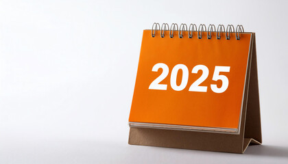 Desk calendar for the year 2025 on a white isolated background.