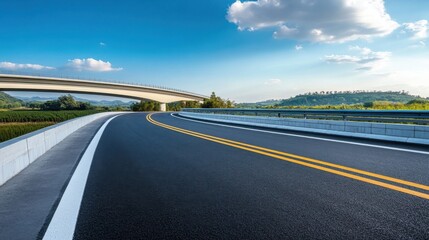 Scenic Curved Road Under a Bridge with Blue Sky
