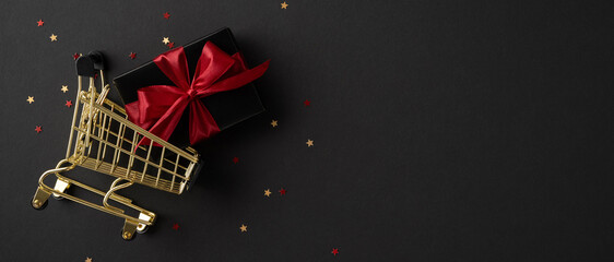 Golden shopping cart with a red ribboned gift box surrounded by small star confetti on a dark surface symbolizing holiday shopping