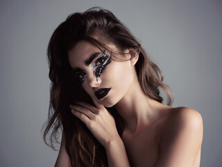 Naklejka premium Pattern, portrait and woman with makeup, eye shadow and beauty of artistic person for aesthetic. Studio, creative design and cosmetics for magical fantasy or face paint isolated on grey background