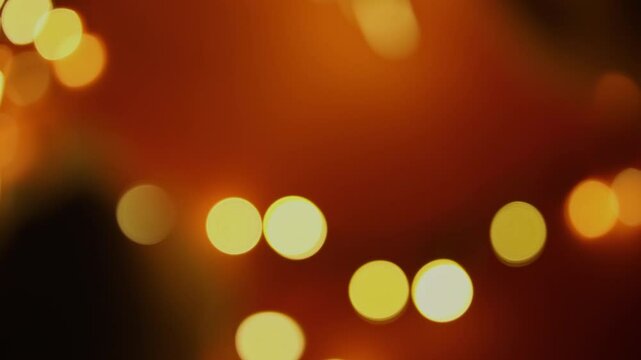 Defocused hands arranging Christmas tree lights. Holiday background.
