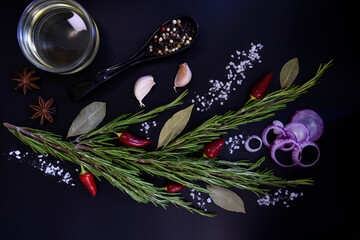 Fresh rosemary in the form of a bouquet with seasonings. Onion, pepper, garlic, bay leaf, salt. Adding flavor and aroma to meat dishes.