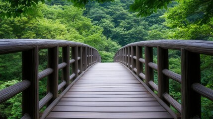 Obraz premium Rustic wooden bridge nestled beneath a lush tree canopy, surrounded by a serene forest landscape, inviting exploration in a charming countryside setting
