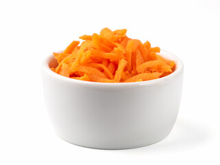 Fresh organic shredded carrots in small white bowl. Raw grated carrots isolated on white with clipping path.