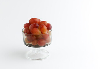 Crystal glasse with red grapes.