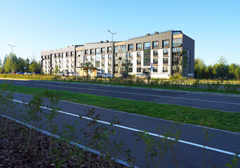 Landscaping for urban spaces and high rise. Planting trees in courtyard urbanization. Modern complex of apartment residential condo building. Young green bushes at pedestrian path in Residential Condo