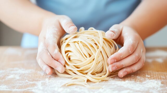 Close up of kid hands in a cooking class with a piece of pasta learning to cook