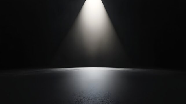 Minimalistic black stage with a bright spotlight highlighting the centre, creating a sense of focus and anticipation