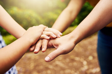 Outdoor, parent and child with hands for stack, celebration and support on vacation by closeup. People, mother and kid with huddle gesture for connection, achievement and bonding together in nature