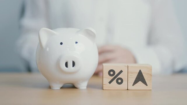 wood block of percentage change to UP and Down arrow with piggy. Interest rate, GDP, stocks market, financial, deflation and Inflation, ranking, mortgage, debt, Loan and Economic Recession
