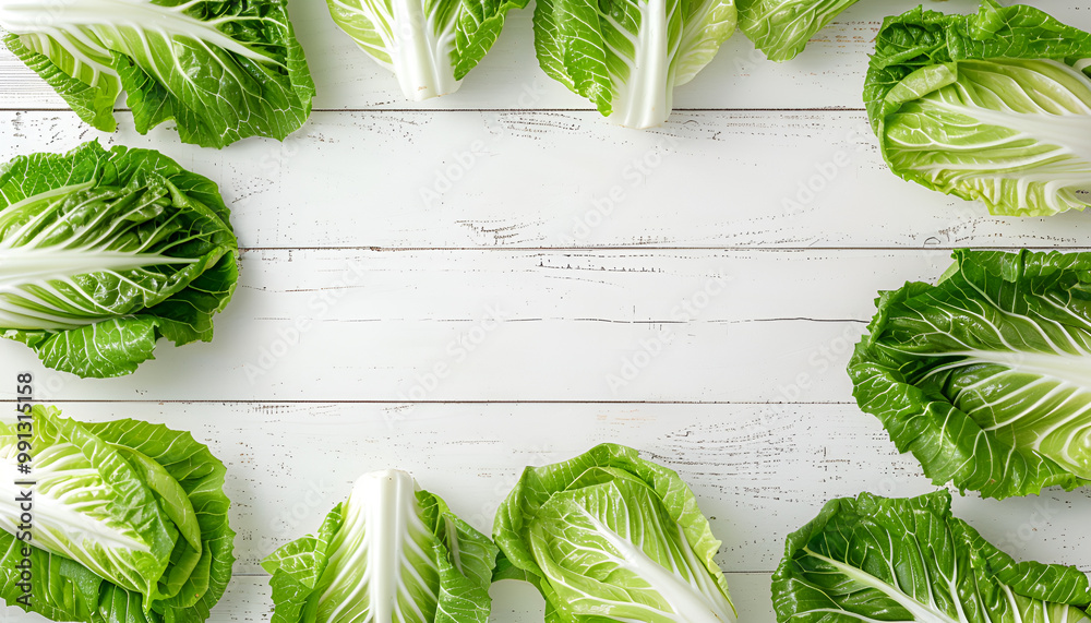 Wall mural frame with fresh ripe leaves of chinese cabbage on white wooden table, flat lay. space for text