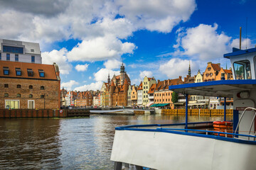 Obraz premium Beautiful city of Gdansk in the margins of the Motlawa river with the touristic boats and coloured buildings